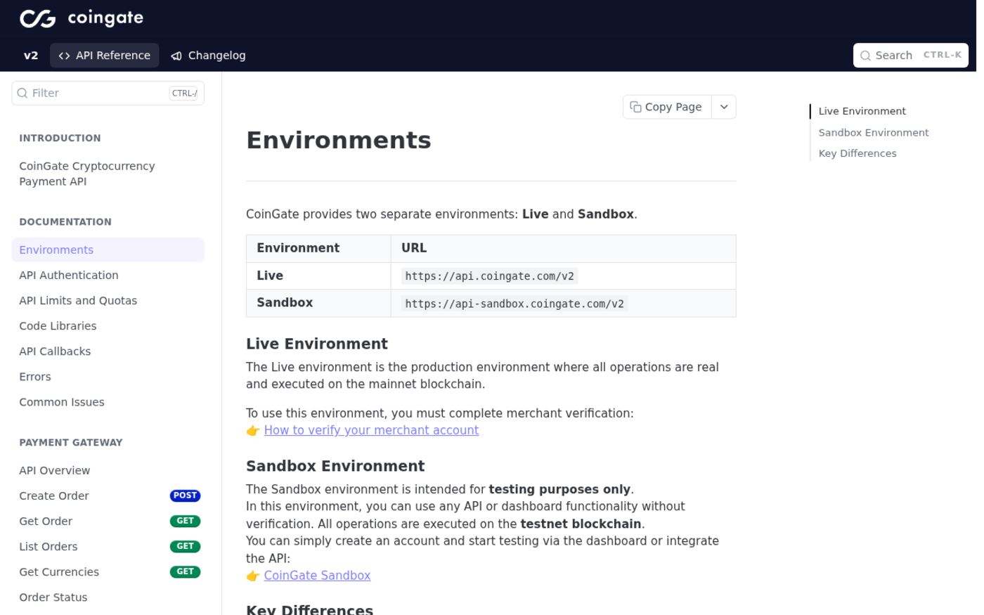 Screenshot of CoinGate's Environments documentation page listing the live host api.coingate.com/v2 and the sandbox host api-sandbox.coingate.com/v2, and stating that the sandbox runs on the testnet blockchain and supports fewer currencies and platforms than live